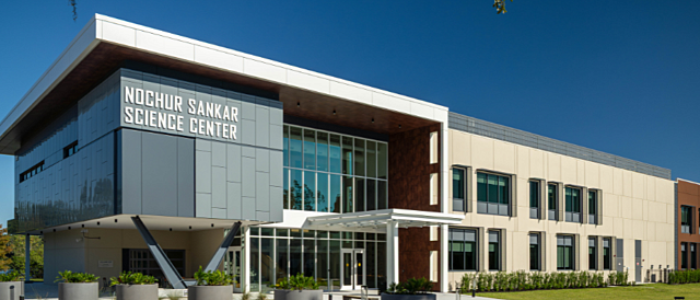 Exterior of Nochur Sankar Science Center with modern glass facade and landscaped entrance.