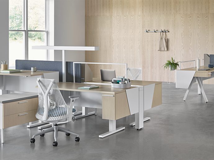 Herman Miller Canvas sit to stand Desks with white and grey Sayl chairs
