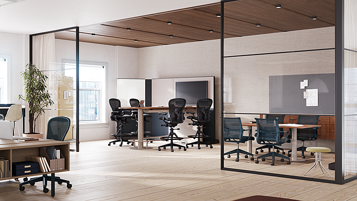 Modern office with glass-enclosed meeting spaces, workstations, and ergonomic seating.